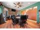 Spacious game room with wood accent wall, large window, ceiling fan, and wood floors at 3955 W Jo Rae Ave, Las Vegas, NV 89141