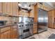 Chef's kitchen featuring a stainless steel stove and refrigerator with custom cabinetry at 3955 W Jo Rae Ave, Las Vegas, NV 89141