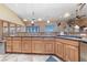 Gourmet kitchen with wood cabinets and a large island perfect for entertaining at 3955 W Jo Rae Ave, Las Vegas, NV 89141