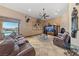 Spacious living room with tile flooring, fireplace, and view of the pool outside at 3955 W Jo Rae Ave, Las Vegas, NV 89141