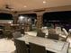 Spacious covered patio featuring an outdoor kitchen, dining area, and scenic night views at 3955 W Jo Rae Ave, Las Vegas, NV 89141