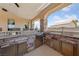 Outdoor kitchen with stone countertops and stainless steel appliances for alfresco dining at 3955 W Jo Rae Ave, Las Vegas, NV 89141