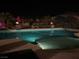 Tranquil pool with artistic fire installations and shaded umbrella seating at 3955 W Jo Rae Ave, Las Vegas, NV 89141