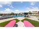 Inviting swimming pool and spa with lounge chairs, lush landscaping, and mountain views at 3955 W Jo Rae Ave, Las Vegas, NV 89141