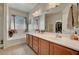 Well-lit primary bathroom featuring a double vanity, soaking tub, and walk-in shower at 4037 Vulcan St, Las Vegas, NV 89122
