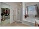 Bright bathroom with tub and shower, plus walk-in closet at 4037 Vulcan St, Las Vegas, NV 89122