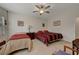 Spacious bedroom with tile flooring, ceiling fan, and natural lighting at 4037 Vulcan St, Las Vegas, NV 89122