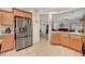 Spacious kitchen with stainless steel appliances, granite countertops, and tile flooring and breakfast bar at 4037 Vulcan St, Las Vegas, NV 89122