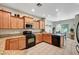 Well-lit kitchen with wood cabinets, granite countertops, and stainless steel microwave at 4037 Vulcan St, Las Vegas, NV 89122