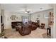 Open living room with tile flooring, ceiling fan, and plenty of seating at 4037 Vulcan St, Las Vegas, NV 89122