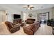 Spacious living room featuring tile flooring, ceiling fan, and comfortable furniture at 4037 Vulcan St, Las Vegas, NV 89122