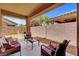 Covered patio with comfortable seating and a view of the landscaped backyard at 4037 Vulcan St, Las Vegas, NV 89122
