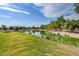 Picturesque view of a tranquil pond surrounded by lush greenery and trees at 4037 Vulcan St, Las Vegas, NV 89122