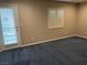 Bedroom with plush carpeting, plantation shutters and a door for patio access at 4121 Erinbird Ave, North Las Vegas, NV 89084