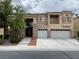 Charming two-story home with a three-car garage and stone accents on the facade at 4121 Erinbird Ave, North Las Vegas, NV 89084