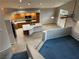 Open-concept kitchen with an island, tile floors, and modern appliances at 4121 Erinbird Ave, North Las Vegas, NV 89084