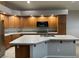 Bright kitchen with abundant wood cabinetry, an island with a sink, and modern appliances at 4121 Erinbird Ave, North Las Vegas, NV 89084