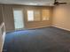Inviting living room with lots of natural light, carpet, plantation shutters and patio access at 4121 Erinbird Ave, North Las Vegas, NV 89084