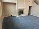 Cozy living room with a stone fireplace, plush carpet, and ample natural light at 4121 Erinbird Ave, North Las Vegas, NV 89084