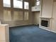 Spacious living room with fireplace, plush blue carpet and plantation shutters allowing for natural light at 4121 Erinbird Ave, North Las Vegas, NV 89084