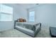 Bright bedroom with plush carpet, large windows, and neutral tones offers a serene retreat at 4376 Latitude Valley Ct, North Las Vegas, NV 89084