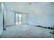 Spacious bonus room with natural light, carpet flooring, and sliding glass door perfect for entertaining at 4376 Latitude Valley Ct, North Las Vegas, NV 89084