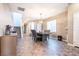 Open concept dining room featuring a modern chandelier, staircase, and easy access to the living spaces at 4376 Latitude Valley Ct, North Las Vegas, NV 89084