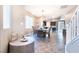 Well-lit dining area features modern light fixture, a large window, and staircase near the dining area at 4376 Latitude Valley Ct, North Las Vegas, NV 89084