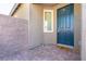 Inviting entryway featuring a teal front door, brick-paved porch, and a charming welcome mat at 4376 Latitude Valley Ct, North Las Vegas, NV 89084