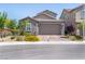 Charming single-story home with stone accents, a well-maintained lawn, and a two-car garage at 4376 Latitude Valley Ct, North Las Vegas, NV 89084