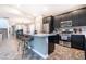 Modern kitchen with stainless steel appliances, breakfast bar, and sleek black cabinetry with ample counter space at 4376 Latitude Valley Ct, North Las Vegas, NV 89084