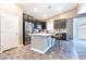 Modern kitchen featuring stainless steel appliances, sleek dark cabinetry, and a island with bar seating at 4376 Latitude Valley Ct, North Las Vegas, NV 89084