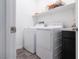 Functional laundry room featuring a washer, dryer, and storage shelves at 4376 Latitude Valley Ct, North Las Vegas, NV 89084