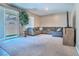 Comfortable living room featuring a large gray sectional sofa, sliding glass door, and neutral carpet at 4376 Latitude Valley Ct, North Las Vegas, NV 89084
