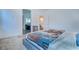 Spacious main bedroom with a view into the bathroom and featuring plush carpeting and neutral walls at 4376 Latitude Valley Ct, North Las Vegas, NV 89084