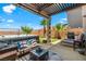 Backyard features a hot tub, seating, lush greenery, and a pergola at 44 Moon Hill Dr, Henderson, NV 89011
