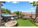 Backyard features a hot tub, seating area, fire pit, and synthetic grass at 44 Moon Hill Dr, Henderson, NV 89011