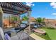 Backyard with hot tub, fire pit, seating area, lush greenery, and mountain views at 44 Moon Hill Dr, Henderson, NV 89011