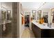 Contemporary bathroom with a glass shower, dual sinks, and access to a spacious walk-in closet at 44 Moon Hill Dr, Henderson, NV 89011