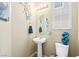 Charming powder room showcases a pedestal sink, decorative accents, and a contemporary design at 44 Moon Hill Dr, Henderson, NV 89011