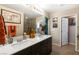 Stylish bathroom featuring a dual sink vanity with modern fixtures and walk-in closet access at 44 Moon Hill Dr, Henderson, NV 89011