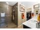Modern bathroom featuring a glass enclosed shower, dual sink vanity, and walk-in closet at 44 Moon Hill Dr, Henderson, NV 89011