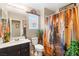 Well-lit bathroom with a stylish vanity, toilet, and shower with decorative curtain at 44 Moon Hill Dr, Henderson, NV 89011
