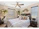 Bright bedroom features a stylish bed, hanging plants, and decorative wall hangings at 44 Moon Hill Dr, Henderson, NV 89011