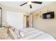 Bedroom featuring closet, TV, wall art, and a plush bed with decorative pillows at 44 Moon Hill Dr, Henderson, NV 89011