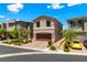 Two-story home shows desert landscaping, paver driveway to a two car garage and a serene blue sky overhead at 44 Moon Hill Dr, Henderson, NV 89011