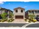 Charming two-story home with desert landscaping, inviting curb appeal and a paver driveway to a two car garage at 44 Moon Hill Dr, Henderson, NV 89011