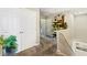 Bright hallway featuring neutral tones, storage closet, greenery, and decorative wall art at 44 Moon Hill Dr, Henderson, NV 89011