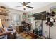 Comfortable home office with ceiling fan, large window, desk, chair, and decor at 44 Moon Hill Dr, Henderson, NV 89011