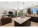 Kitchen island with stylish pendant lights and views of the living room and backyard at 44 Moon Hill Dr, Henderson, NV 89011